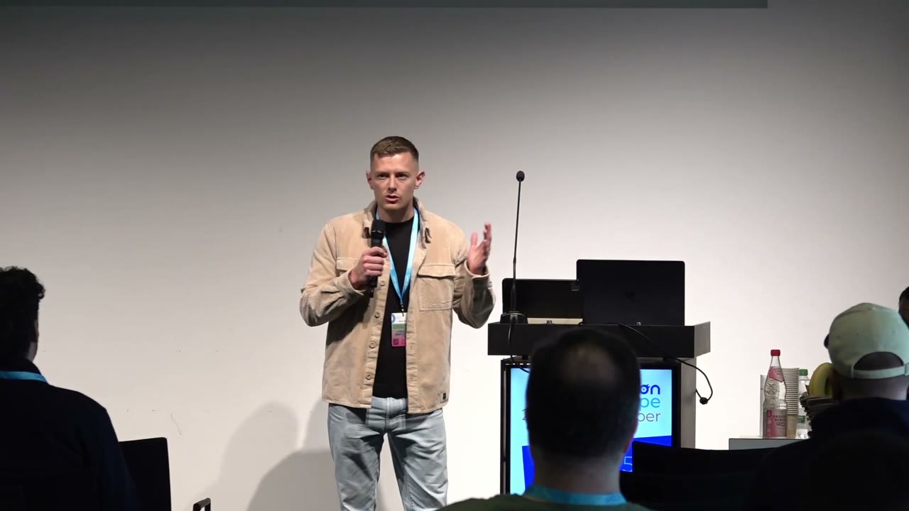 Michael McRoskey speaking on stage at FlutterCon Europe